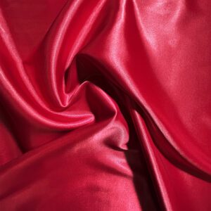 Shiny red silk fabric with smooth folds.